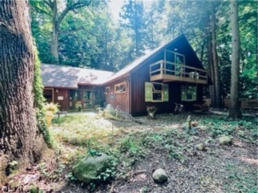 Magical, woodland retreat nestled along the edge of the Ashtabula River. The .5 acre lot boasts old growth oaks, beech & ancient hemlocks, breathtaking view of the River and tranquil sound of the waterfall. The cedar sided cape cod offers great room w/gas fired stone fireplace, built-in dry bar, oak flooring throughout, lots of sliding doors & windows allowing natural light to stream in. Galley kitchen with new butcher block counters, live edge wood breakfast bar, ss appliances. Main level bedroom has convenient attached bonus room for media/reading/office, centralized laundry and main bath. The second story houses 2 bedrooms and full bath w/skylight. Lots of closets and walk in attic space for storage. 2 car attached garage, workbenches, more storage, relax in the cool breezeway. Huge 40' x 10' wrap around composite deck for outdoor living and entertaining, large wooded yard, river rock trails and driveway. Cedar fencing runs along the side boundaries for added privacy. Come - connect with nature - live within a forest - yet near all city amenities. A truly unique place!