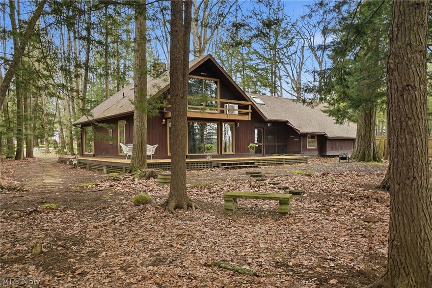Magical, woodland retreat nestled along the edge of the Ashtabula River. The .5 acre lot boasts old growth oaks, beech & ancient hemlocks, breathtaking view of the River and tranquil sound of the waterfall. The cedar sided cape cod offers great room w/gas fired stone fireplace, built-in dry bar, oak flooring throughout, lots of sliding doors & windows allowing natural light to stream in. Galley kitchen with new butcher block counters, live edge wood breakfast bar, ss appliances. Main level bedroom has convenient attached bonus room for media/reading/office, centralized laundry and main bath. The second story houses 2 bedrooms and full bath w/skylight. Lots of closets and walk in attic space for storage. 2 car attached garage, workbenches, more storage, relax in the cool breezeway. Huge 40' x 10' wrap around composite deck for outdoor living and entertaining, large wooded yard, river rock trails and driveway. Cedar fencing runs along the side boundaries for added privacy. Come - connect with nature - live within a forest - yet near all city amenities. A truly unique place!