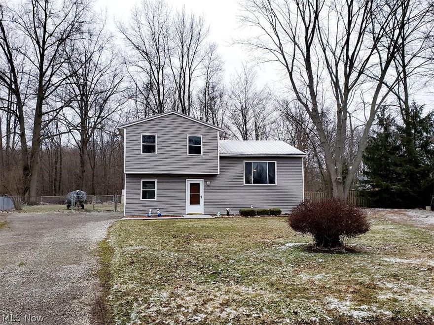 This is definitely one of those "feel good" houses where you know the seller has taken great pride in maintaining his home! The coziness begins as soon as you walk into the front door! As you enter the large foyer it has a double coat closet and plenty of space to bring in your own personal decor and ideas! Just off the foyer is an oversized family/rec room that has a sliding glass door that leads to a concrete patio and completely fenced in rear yard!  Nice size  shed that has a concrete floor and electric!  Great place to store your mower and tools! The laundry room has access to the crawl space where there is tons of extra storage space! Owner has a small firepit set up made for fun family gatherings in the rear yard! New metal roof in 2019! Other updates include newer vinyl siding, hot water heater, carpet, front door and windows!  Large living room is open to the dining room and kitchen!  All appliances stay including the washer and dryer!  You won't believe how cheap the utility
