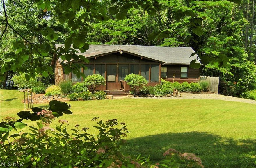 Waterfront on Sunset Drive is the ideal location for this quintessential Seneca Lake retreat. Dock your boat or Jet Ski at your nearby dock and proceed to the deck overlooking the water or spend time on the large screened–in porch in the front of the house. Entering the cottage from the front porch you are greeted by an open floor plan that includes the kitchen, dining area and family room.  These three areas have recently been renovated and include, new drywall, new wiring, recessed lighting and laminate floors. The sunlit kitchen’s brightness is enhanced by white cabinetry & an island with granite counter top providing additional seating, a large work area or a perfect area for serving your guests. The adjacent dining area is large enough to provide seating for 6-8 guests. The family room features cathedral ceilings, a ceiling fan and a new 3 panel sliding door that leads to the waterfront deck. The cottage features an extensively remodeled bathroom with new wiring, flooring, plumbin