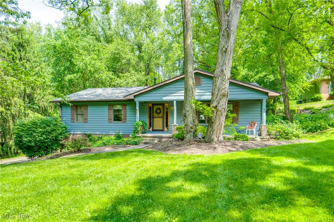 Take a look at this custom raised ranch that combines comfort, space, and character in every corner. Nestled in the Green School District, this property boasts 3 spacious bedrooms and 2 full bathrooms, offering both functionality and style. Step inside to a warm and inviting vaulted ceiling living area that flows seamlessly into a large kitchen that features an abundance of storage, counterspace and an island! —perfect for entertaining or cooking with family. The main bedroom features its own private en-suite full bath, making it an ideal primary suite! You'll love spending time outdoors on the covered front porch, a great spot for morning coffee or evening relaxation. The tree-lined backyard offers privacy and shade, making it a peaceful oasis for play, gardening, or gatherings. Need extra storage or workspace? This home also includes an additional garage—perfect for a workshop, hobby area, or classic car or motorcycle storage. Don’t miss the opportunity to own this wonderful home! Schedule your showing today and discover all it has to offer!