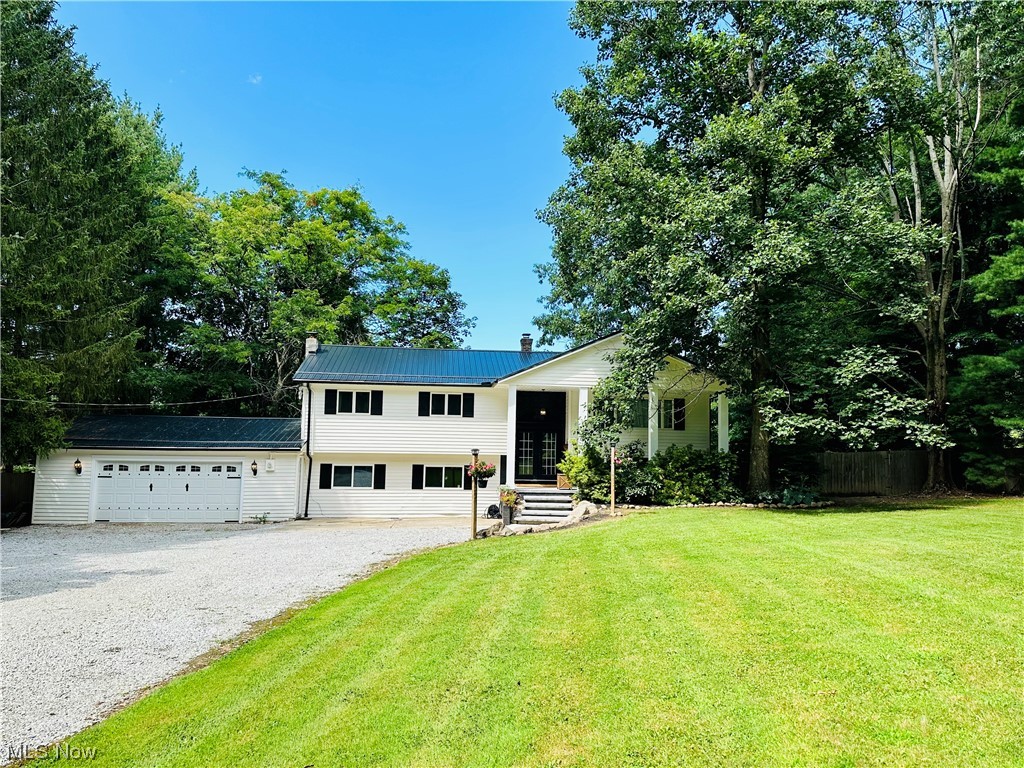 Welcome Home!!! Nothing to do but move in. Pride of ownership went into updating this beautiful home from top to bottom inside and outside in Munson Township. Sitting on over 1.5 acres, this home boasts a gourmet kitchen with top of the line Kitchen Aid appliances, quartz countertops, kraftmaid cabinets, oversized hood range. Off the kitchen is the open dining room and living room with vaulted ceilings. Enjoy your morning coffee on the 3 tiered deck overlooking the private fenced in back yard. On the main floor there are 3 bedroom with wood flooring and 2 beautiful custom bathrooms. The downstairs family room has a wood burning fireplace and sliding doors leading to the lower deck area. You will find the 4th bedroom and full updated bathroom and laundry room with a barn door beside the large great room with a wood burning stove, mud room and workshop area. So many updates: new Septic, 40 year metal roof, gutters, downspouds, landscaping, garage door, man doors, main front door, privacy