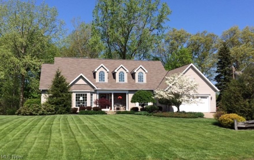 Spacious Cape Cod on half acre wooded lot! 4 bedroom, 2 full, 2 half bath open floor plan with UPDATES THROUGHOUT! Two-story designer foyer, vaulted great room w/9 ft. windows and floor to ceiling fireplace. Entertainment style open kitchen/dinette. First floor master bedroom suite with fireplace and glamour bath with vaulted ceiling/skylight and FP. 3 bedrooms up with open walkway. 1000 sq. ft. finished basement and professional workshop. Two-level custom deck. Storage, Storage, Storage! Mentor School System - great neighborhood!