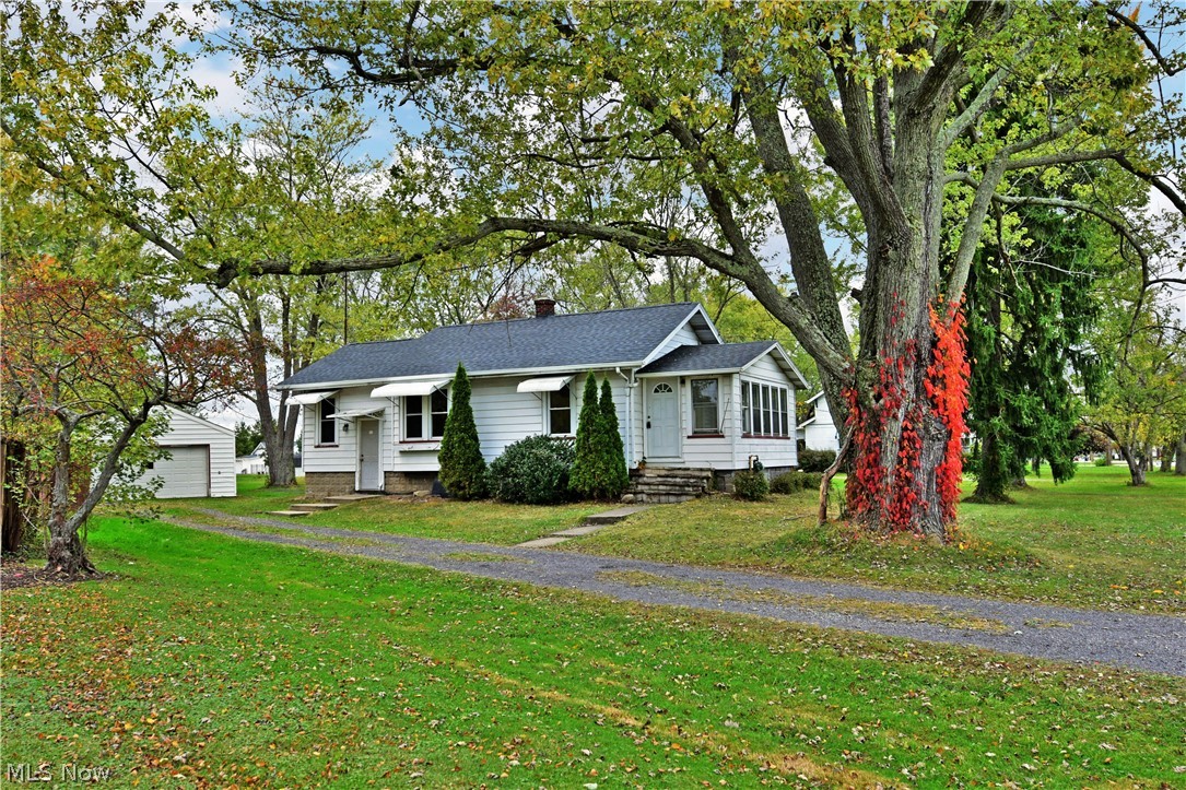 This absolutely adorable ranch style bungalow in Champion Schools is ready for you! Welcome home to 5985 Mahoning Ave NW! Located across from the brand new school, this charming home features an open concept living room and dining room with original built ins around the bay window and in the dining area, low maintenance wood look laminate flooring through out, an updated kitchen with beautiful wood cabinetry, 2 nicely sized bedrooms, newer lighting, and an updated bath! A new roof was just installed on the house and garage 10/19, a new sump pump was put in in 2015, flooring 2013, bathroom vanity 2019, new ceiling fans 2019, fresh paint 2019, and fresh gravel for the drive in 2017. All of this plus a 1 year home warranty! What are you waiting for? Call today for your personal tour!