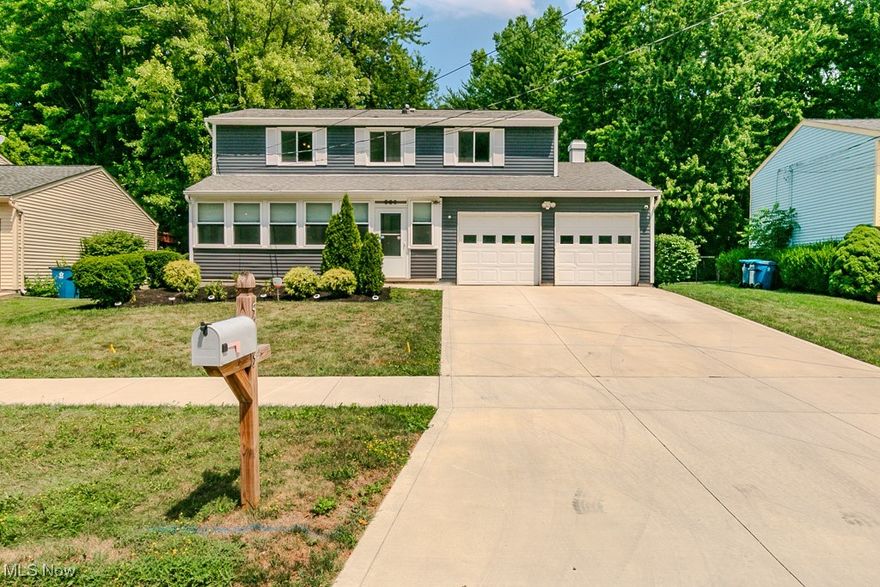 This home has been waiting for you! With fresh paint and brand-new carpet, there’s nothing left to do but move right in. The beautifully painted blue siding gives this colonial standout curb appeal, paired with two covered outdoor spaces and a double garage with openers. The fully enclosed front porch welcomes you with a newer storm door, front door, and updated finishes—perfect for relaxing with your morning coffee. Inside, the living room features a large front window and flows seamlessly into the dining room, both refreshed with new carpet and paint. The kitchen offers warm wood tones, ample cabinet space, and a versatile movable island that can be positioned to suit your cooking and entertaining needs. Conveniently tucked between the kitchen and garage, you’ll find the first-floor powder room. The spacious family room boasts a stone fireplace and opens to the covered back deck and an uncovered concrete patio—ideal for year-round enjoyment. The fully fenced backyard features white vinyl fencing with a double-sized gate for easy access. Upstairs, you’ll find four bedrooms and two full baths, including a primary suite with overhead lighting, a vanity area, a walk-in closet ready for your custom organizer, and a refreshed en suite bathroom with a standing shower stall and pedestal sink.
The lower level is ready for your vision, offering potential for a recreation room, laundry area, and generous storage, including a crawl space. Recent updates include: Hot water tank (July 2025), Driveway (2023), Carpet (August 2025). The seller is including a one-year home warranty for peace of mind. Schedule your showing today and make this charming, move-in ready home yours!