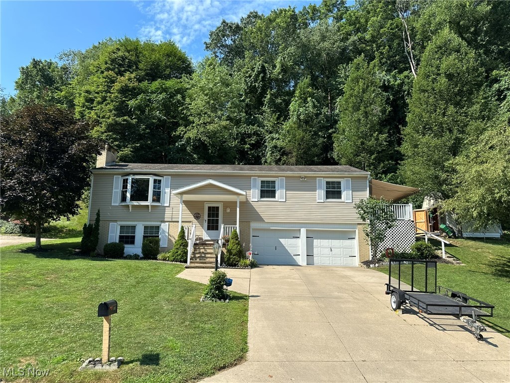 WELCOME HOME... this raised ranch/split level is in immaculate condition with 3 bedrooms, 2 full bathrooms, an all-season room, bonus family room in the basement with a stone fireplace and a walkout deck from one of the bedrooms...deck includes a retractable awning. Overlook the neighborhood from the large bay window in the living room, watch the wildlife from the all-season room or the oversized patio out back. Storage shed for all of your outdoor equipment and tools. Home is wired for a portable generator. Tons of storage.