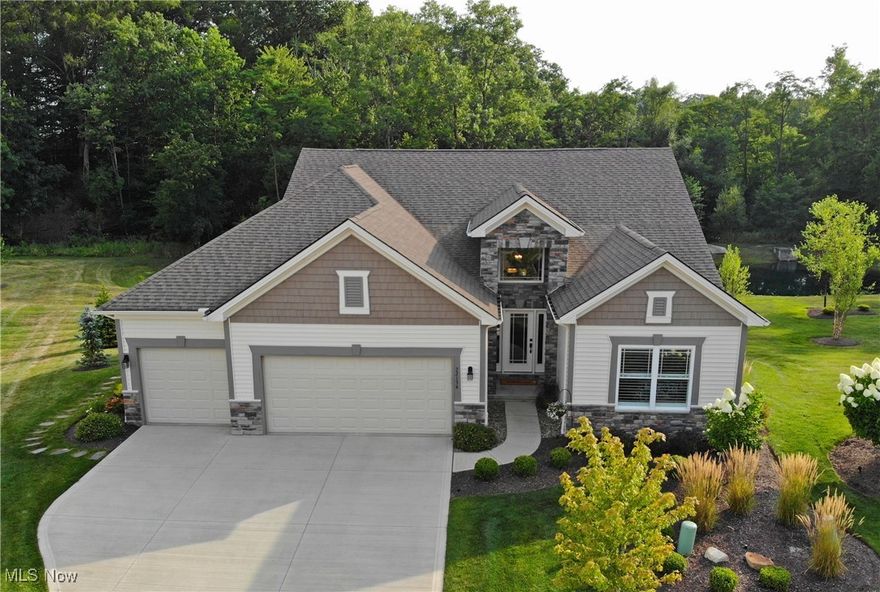 Welcome home to this beautiful 3-Bedroom + Den - luxury-limited maintenance 3-car garage Villa on a private cul-de-sac.  It features 3,139 total sq ft with an amazing walk a out basement! This 4 year old finely appointed home has it all! Wood looking tile floors throughout most of the 1st floor. Foyer/Entry features tall ceilings, chandelier and wainscotting. The open Kitchen includes granite counters w/leather finish, large oversized island, white maple cabinetry, wood hood, stainless appliances w/double oven, tile backsplash, 3 pendants and vaulted ceilings. The Kitchen opens to the Vaulted Great Room with a stone facade to the gas direct vent fireplace and w/private bar, granite countertop, storage and a barn door. The vaulted Sunroom brings all the sunlight in from the private rear yard. The covered composite deck is great for entertaining overlooking the community private pond with a fountain. The Primary Bedroom includes a tray ceiling with crown molding and attached sitting room overlooking the private rear yard.  The Primary Bathroom includes tile flooring, double bowl vanity with granite countertops, custom tile shower and double walk in closets that also attach to the laundry room. Laundry Room features a stacked washer/dryer, closet, cabinetry with quartz countertops and a sink. The office includes carpeting and glass doors. Bedroom #2 is on the 1st floor and is right next to the Main Bath which includes at tub/shower and granite countertops.  The stairs to the finished walk out basement has black metal spindles and craftsman style newel posts.  The 950 sq ft of finished living space in the walk out level includes a billiard table, barn door, living space, a private office area and the 3rd Bedroom with a full bath. The glass slider in the lower level opens to the large stamped concrete patio for additional entertaining space and overlooks the community pond with a fountain. Full yard Sprinkler System and Security System. All appliances stay!