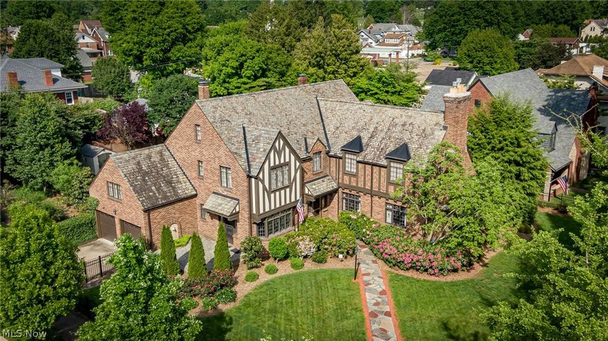 Sited on two landscaped city lots with perimeter fencing, this Landmark 1939 European Tudor features an array of rooms and elegant appointments. The residence is a fine period piece for collectors as well as modern and efficient. The living spaces are light filled and welcomes 5800 square feet of restored perfection. The two story entry hall features carved staircase, forged iron work, lead glass windows and upper gallery. The formal rooms are appointed with handsome lead glass doors that open to covered veranda, making this the perfect venue for entertaining or relaxing. Two fireplaces create warmth and ambience in the formal living and family rooms. You will enjoy garden views in the eat in kitchen that features original stainless counters, walk in pantry and access to private back. An adjoining breakfast room or study is ideal for morning gatherings. The music room overlooks the front grounds that are a rainbow of colors in handcrafted stain glass that is illuminating and warm. The