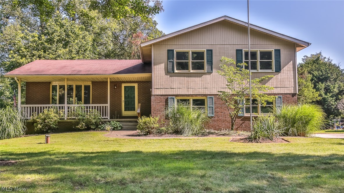 Executive sized Four level Split nestled on over an acre of beautiful wooded land. This lovely home features a large front porch & a newer rear deck overlooking back yard. Home has been completely renovated and ready to move in. Kitchen has been opened to formal dining Room and a butcher block breakfast bar was added & just waiting for bar stools. All flooring has been replaced including Beautiful vinyl laminate in Living Room, Dining Room Kitchen and family room. All bedrooms have brand new quality carpeting The entire interior was professionally painted and all 3 baths have been updated including master bath. There is a private office or craft room on the lower level plus plenty of unfinished area for projects. All the bedrooms are huge with plenty of closet space. There is a newer high efficiency forced air furnace with central air.