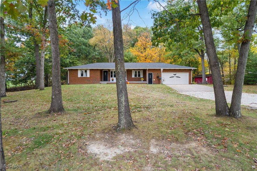 Welcome to this beautifully updated brick ranch nestled on 1.59 acres in Perry Township. Surrounded by mature trees, the park-like backyard offers a serene retreat. As you step through the front door, you’ll be greeted by an open floor plan designed for family gatherings, featuring new flooring throughout for a seamless flow. Cozy up by the fireplace in the inviting living area.

The main level includes a spacious primary bedroom with an ensuite bathroom, a second bedroom, and a full bath, along with convenient first-floor laundry and a half bath. The updated kitchen has plenty of counter space for entertaining the whole family. Step outside to the charming three-season room, where you can enjoy stunning views of the expansive yard.

The lower level boasts another large bedroom and a family room, providing ample space for relaxation and entertainment, along with plenty of storage options. This home is ready for you to create lasting memories. Don’t miss out on this exceptional opportunity!