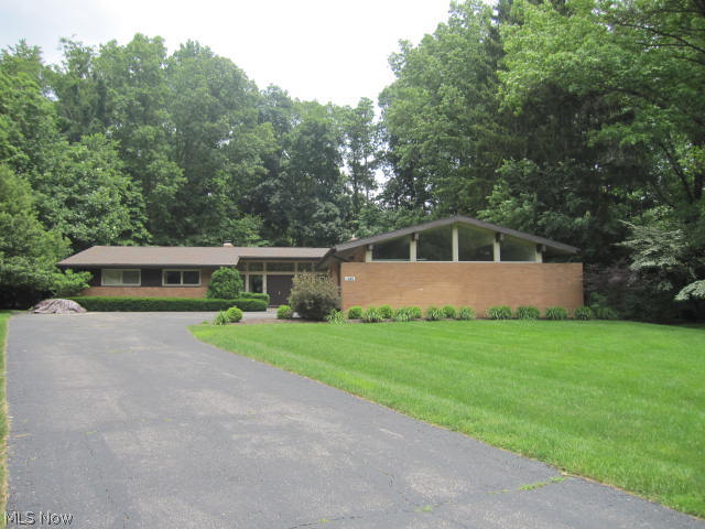 Fall in love with this striking contemporary ranch loaded with mid century modern design elements. Sunken living room with vaulted ceilings with gorgeous fireplace, walks out to a large screened and covered patio. Huge open foyer leads to family room, living room and bedrooms. This is first floor living at it's finest. Vaulted kitchen that is open to vaulted family room. Walk in pantry off kitchen. 4th bedroom is off kitchen adjacent full bath and would be great for guests. Master suite is 14 x 16 and has plenty of closet space. New roof in 2014, new furnace in 2014. Private wooded lot that pies out to the back. It's a must see home with immediate possession.