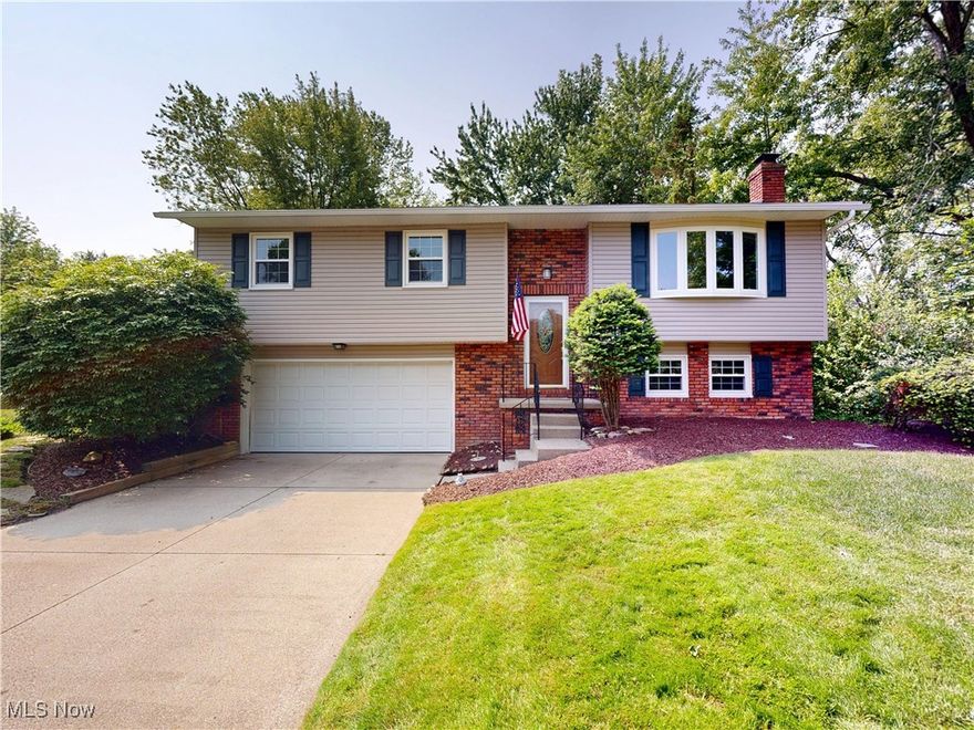 Welcome to your own slice of serenity in one of Mentor’s most desirable neighborhoods! This beautifully updated 3-bedroom, 1.5-bath bi-level home is tucked along a quiet residential street and offers the perfect mix of modern comfort and natural charm. Inside, you’ll find a fresh, move-in ready interior with nearly every detail refreshed—neutral paint, newer flooring, updated trim, doors, and stylish fixtures. The upper level features a bright, spacious living room with a large bay window, a dining area with sliding glass doors that open to a raised deck, and a functional kitchen with a pantry and brand-new 2024 appliances. Whether you’re cooking dinner or enjoying a quiet morning coffee, the dining area and kitchen offer gorgeous, peaceful views of the lush backyard. It’s a truly calming backdrop filled with mature perennials—your own private, park-like retreat perfect for entertaining, gardening, or simply relaxing outdoors. The full bath is tastefully updated, and all three bedrooms offer comfortable space with upgraded closet doors and hardware. Downstairs, enjoy a cozy family room with a brick-surround fireplace and wood accent walls, plus a convenient half bath, a laundry room with washer and dryer included, and plenty of storage. Additional highlights include a 2-car attached garage, a brand-new roof, an updated electrical panel (2025), and all second-floor windows replaced in 2025. Ideally located near Wildwood Park, shopping, dining, and major highways (Routes 90 & 2), this home is a rare opportunity to enjoy both comfort and convenience. Don’t wait—schedule your private showing today and come see everything this beautiful home has to offer! 1-year Home Warranty included!