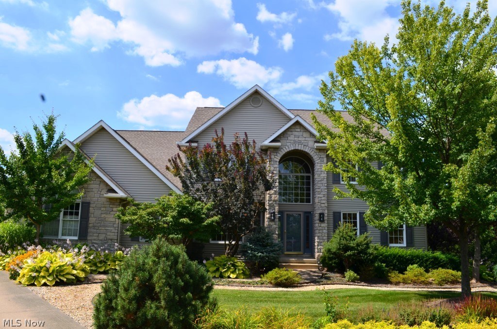 Stately colonial nestled on almost half an acre in the desirable Rosemont Ridge subdivision. Updates include newer roof, furnace, and hot water tank. Welcoming home features two story foyer with view of rooms beyond. Glass French doors lead to handsome office with chair molding and multiple windows. Elegant formal dining room boasts bayed windows and tray ceiling with crown molding. Bright and open kitchen offers breakfast bar, ample cabinetry, ceiling fan, tile flooring, and separate eating area with sliders to deck. Dramatic, two story great room presents vaulted ceiling, mantled fireplace, wall of windows, and view of second level. First floor laundry room and guest bath conveniently located. Spacious master bedroom suite highlights vaulted ceiling with fan, large walk-in closet, and glamour bath with jetted tub and double vanities. Three additional, generous sized bedrooms and main full bath complete second level. Fabulous finished lower level features family room with ou