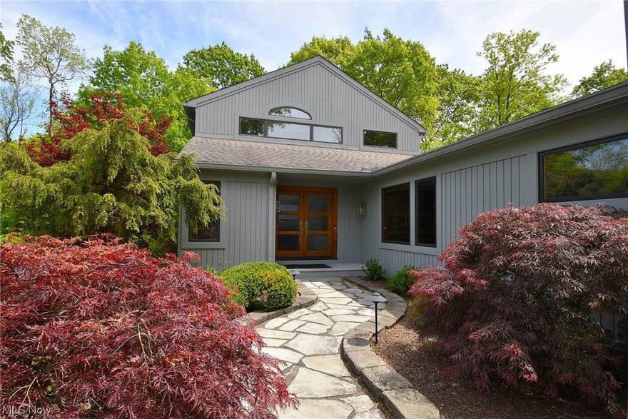 Distinctively modern custom designed home on a 1.88 scenic acres on a quiet culdesac in desirable Chagrin Valley Trails! Open and bright layout with many upgrades and recent updates. Gracious entry that leads to the 2 story great room is highlighted by the floor to ceiling stone front fireplace and walls of windows overlooking the private backyard and newer multi-tier decking and a perfect setting for entertaining! Formal dining room with hardwood flooring leads to the gourmet kitchen with upscale Wolf and Subzero appliances, granite counters and large center island. Private office/study both includes hardwood flooring and custom built ins. Main floor spacious owner’s suite with a private balcony, custom walk-in closets and a beautiful private bathroom with free standing tub, tiled shower and double vanity. 2nd floor includes 3 additional spacious bedrooms and 2 full baths. One bedroom features an updated on-suite bath with walk-in shower; 2nd hall updated bath includes large double si
