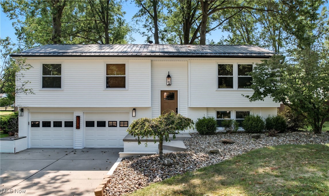 Welcome to this beautifully updated & landscaped three-bedroom, two-bath bi-level home offering 1,620 square feet of comfortable living space in Howland Schoold District. Recent updates include a brand-new metal roof and siding (2024), an updated electrical panel (2019), fresh paint and newer vinyl plank flooring throughout. The spacious master suite features its own full bath, while the modern kitchen is a true standout with Kraftmaid cabinetry, quartz countertops, and all stainless appliances included—stove, refrigerator, dishwasher, microwave. The lower level provides a versatile family room or playroom along with a convenient laundry area (washer & dryer will stay). Outside, relax on the back deck overlooking a private tree-lined yard complete with a jungle gym and storage shed that stay with the home. A two-car attached garage adds even more convenience to this stunning property. Truly move-in ready, this home blends style, comfort and thoughtful updates throughut—schedule your showing today!