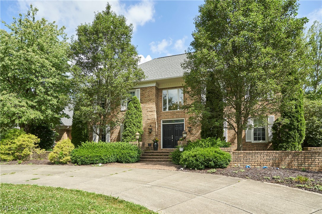 Welcome to this beautifully updated all-brick Colonial in the desirable Sanctuary of Bath neighborhood. Set on a full acre with a circular driveway and 3-car garage, this 5-bedroom, 5.5-bath home offers a comfortable layout with plenty of space to spread out. Inside, you'll appreciate the fresh, contemporary updates throughout, including a new roof (installed in 2023), renovated bathrooms, new flooring, fresh paint, and more. The two-story foyer opens to a bright living room with fireplace and a formal dining room. The kitchen features newer appliances including double ovens, a large center island, and a walk-in pantry, and flows seamlessly into the spacious family room with fireplace, wet bar, and access to the back deck. A private home office, laundry/mudroom with full bath, and a half bath complete the first floor. Upstairs, you’ll find five bedrooms and four updated full bathrooms, including a spacious primary suite, two ensuite bedrooms, and two that share a Jack-and-Jill bath. Multiple access points lead to the large rear deck overlooking the fenced backyard, perfect for everyday living or entertaining. Located in the award-winning Revere School District with public water and sewer, and just minutes from Montrose shopping and highway access for an easy commute to Akron or Cleveland. Schedule your private tour today!