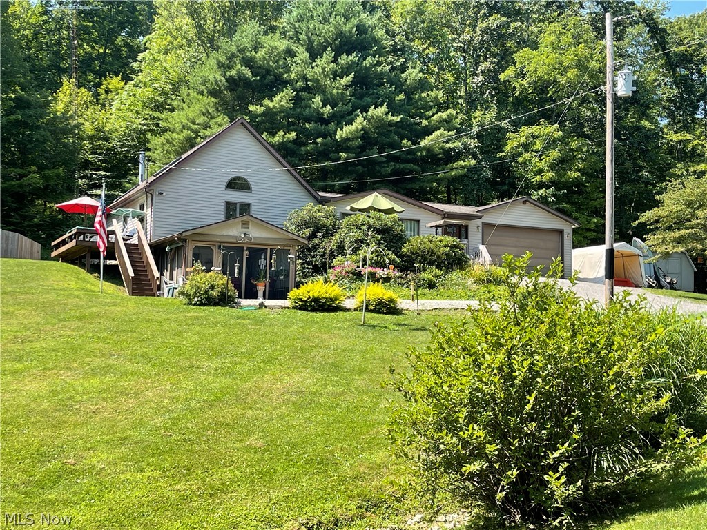 Beautiful country setting for this well maintained home. With 2-3 br, open layout with large living room with sliders leading to a large deck overlooking a 1/2 acre stocked pond 10-12 ft deep appox. with a propane fireplace and kitchen has cathedral ceilings with skylights and large dining area with new flooring in kitchen and dining room. Open loft overlooks the spacious dining area and kitchen which comes equipped with appliances and first floor laundry which leads to private large newer deck. First floor bedroom with double closets and full bath, and there's a jacuzzi tub with skylights to sit and relax like your at the spa. The partially finished walkout basement has a kitchenette with full bath and lots of storage/closets. There's room with another bedroom, family room area or recreation area, which ever you prefer. Enjoy the enclosed sunroom/screened in porch and the view is just beautiful with all the flowers and wildlife. There's an attached 2 car garage with a prop