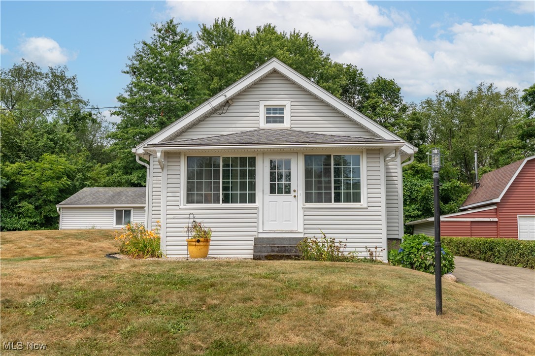 Look at this move in ready 2 Bedroom home in Mogadore Schools with additional 2 parcels. Updated fully applianced kitchen with white cabinets. New paint and carpet throughout. Updated bathroom with shower. Full unfinished basement with washer and dryer. Additional shower in basement. Large two car garage with opener. Large Shed. Vinyl siding, newer windows and roof. Enclosed front porch. Deck off the back of home. Concrete driveway.