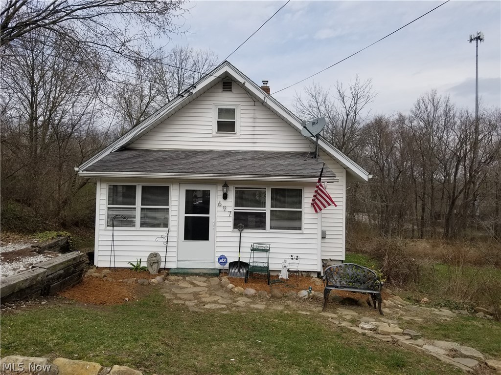 Inviting Cape Cod with 3 City Lots located at the end of dead end street w/ 3 bedrooms and 1 bath. Pergo floors adorn the spacious and inviting living/dining room with a wood burning stove. Laundry with nature stone floors and glass block windows, located in the walkout basement that has 1 bedroom, workshop area and 1 car garage. Dining room with wood burning stove gives access to a 24x14 wood deck that over looks the very spacious 3 city lot back yard with 2-12x8 storage sheds. Large Sunny Enclosed front porch greets you as you enter this adorable New home you can call your own!!!