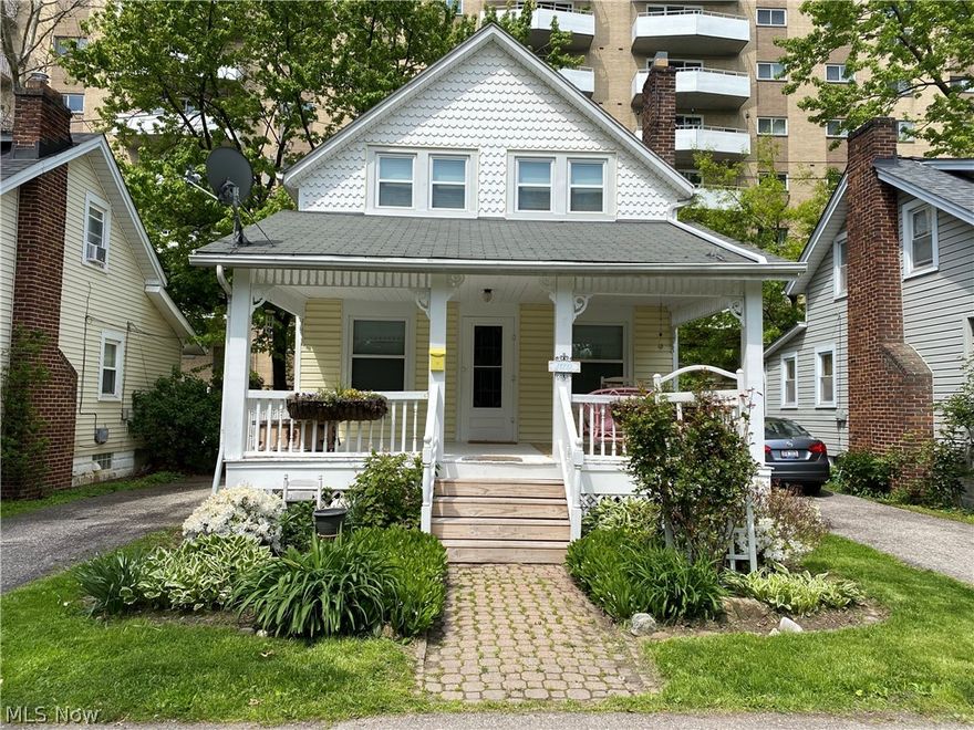 Are you looking for your very own fairy tale home? Or perhaps an easy income generating investment property? This sweet cottage is it! It's loaded with charm, located on a private street and steps away from Lake Erie. The huge, inviting front porch is the perfect place to enjoy a Cleveland summer day/night. Enter into a spacious, light filled living room with original hardwood floors and freshly painted fireplace, which opens to the dining room and kitchen. Kitchen has been updated with new quartz countertops, painted cabinets, flooring and stove. All appliances stay! Upstairs you'll find two bedrooms (front large bedroom can be converted back to two rooms as it once was) and a full bath with a refurbished clawfoot tub. Basement with vented glass block windows houses laundry, utilities, and plenty of storage. Additional updates to the house include all new windows & blinds, Simply Safe alarm system, updated electrical, and new ceiling in living room.  This quiet, private street feels l