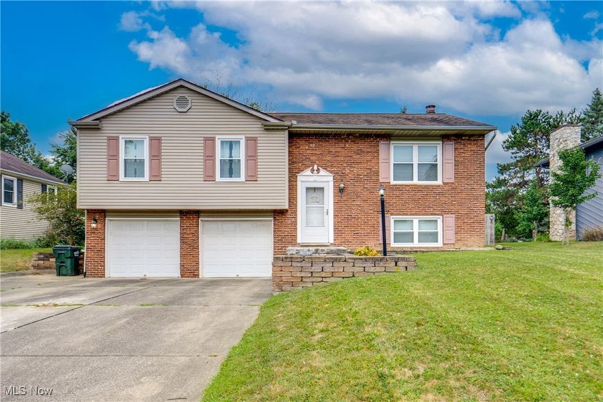 Welcome to this beautifully updated and well-maintained home in the desirable North Canton Local School District! Offering three bedrooms, one full bath and two half baths. The main level features a spacious living room with crown molding. It is open to the dinette and updated kitchen, complete with refaced cabinets, tile backsplash, engineered hardwood floors and sliders leading out to a 12x15 deck—perfect for outdoor entertaining. The remodeled full bath boasts a tub/shower combo. All three bedrooms have ample closet space, with the primary suite including its own private half bath. The finished lower level provides even more living space, highlighted by a family room with luxury vinyl plank flooring, a cozy wood-burning fireplace with brick surround, white wainscoting, and windows overlooking the front yard. Enjoy a fully fenced backyard with a privacy fence, plus an oversized 2-car attached garage with extra depth for storage. Schedule your showing today!