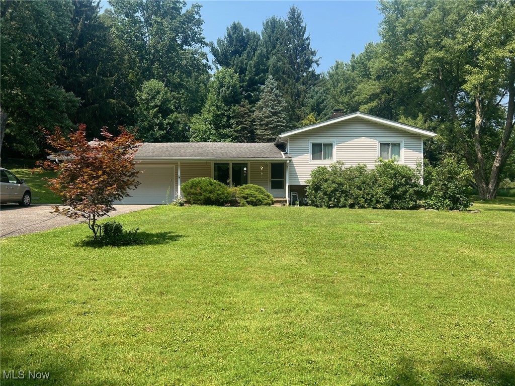 Welcome to 10504 Mulberry Rd. What a unique property! This 3-bedroom split level is waiting for you to bring your ideas to life. Beautiful hardwood flooring throughout most of the home. The large living room offers an abundance of natural light. It is open to the dining room with a slider out to the back yard, and what a backyard it is! This two acre lot offers a private hillside retreat. Walk to the top of the hill to enjoy the park like atmosphere and perfect sledding hill. The 30 x 20 pole barn with loft offers so much storage and so many possibilities. There is a rec room in the basement with a wood-burning fireplace and water closet that could easily become a second bath. It also has more storage! This is an estate and sellers will make no repairs. Lilies in front yard and winch in barn do not convey.