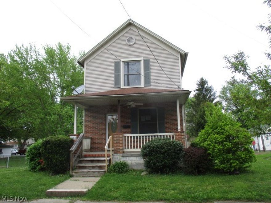 Vinyl sided 2 story with cozy front porch, large rear deck with walk out basement, central air and detached garage.