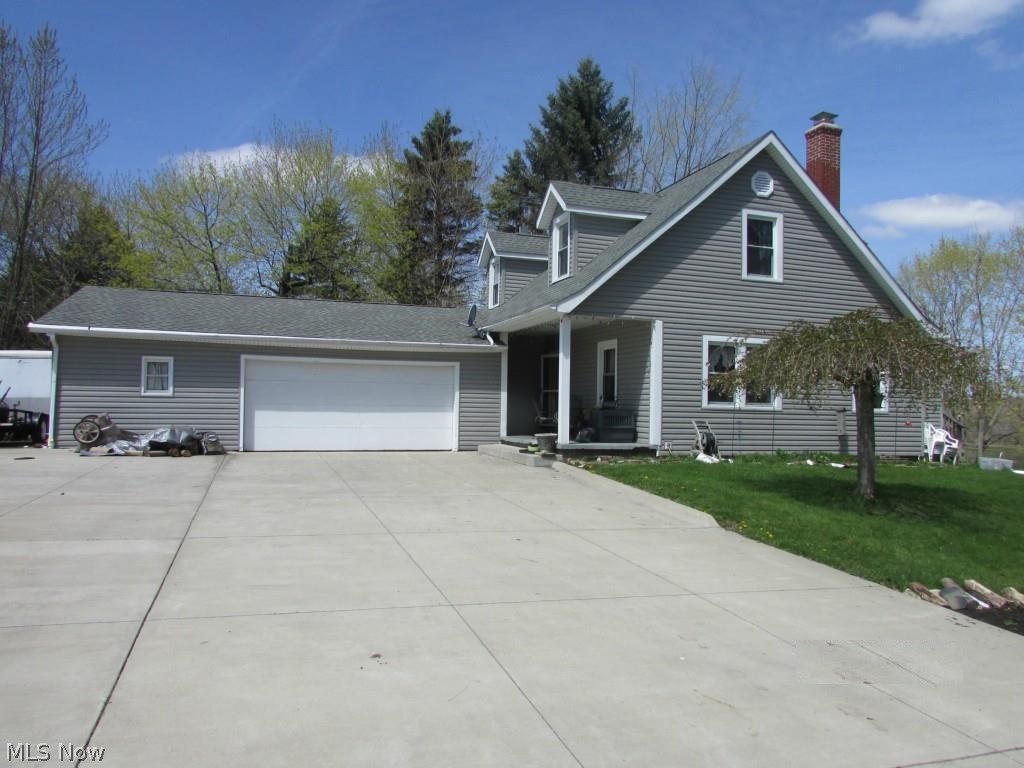 Rare find in a gorgeous country setting, 1.5 acres overlooking rich farmland. This spacious 3 bedroom home is waiting for someone to add decorating touches to make it perfect! Kitchen features newer stainless appliances. First floor has Bedroom and Office. Natural wood floors under most carpet. This home has maintenance free vinyl siding and a newer dimensional roof. There's a huge garage (will easily fit 3 cars) with 2 car door plus attic storage. At the approach to the house there's a huge portion of concrete drive that's perfection for parties and turning around in drive. There's a nice sized front porch with overhang that has a beautiful view of the countryside!
