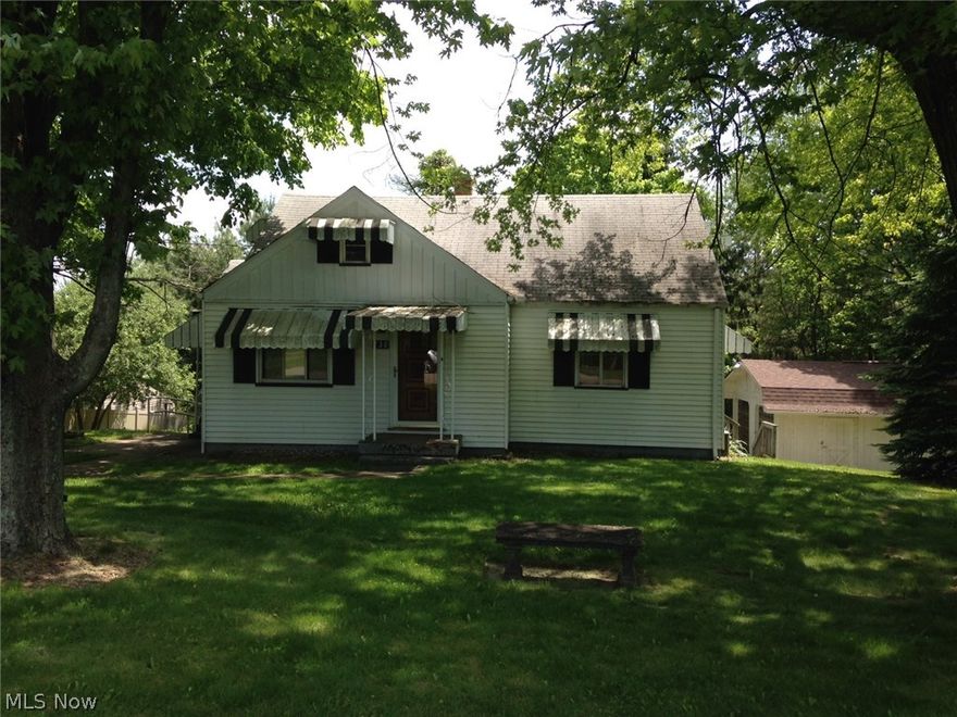 1 1/2 story 4 bedroom home on a one acre lot. Large eat-in kitchen. One car garage in basement. Two car detached garage. Covered rear deck (very private). Sellers anxious to sell. Immediate possession.