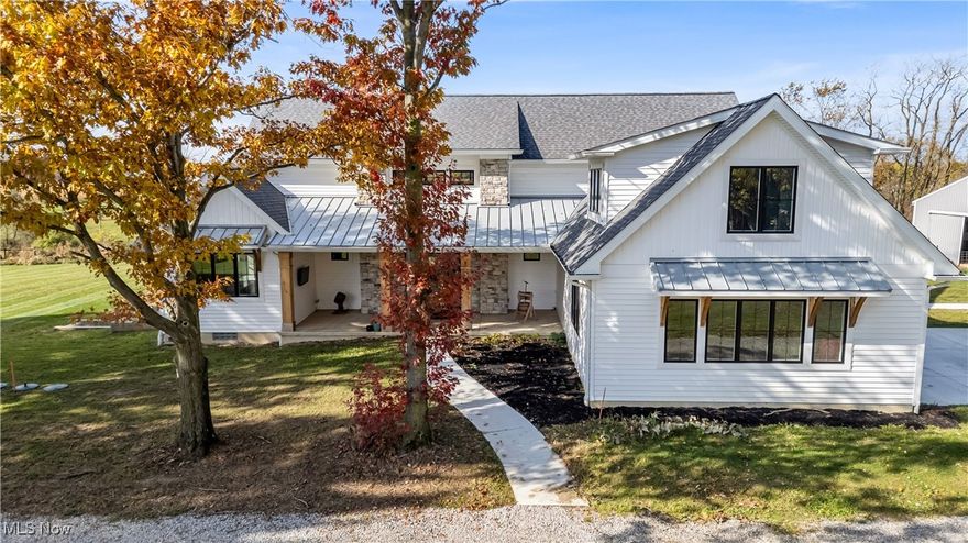 A must see 3-year-old like new architectural designed 4278 sq ft home located on 11.03 acres. This quality custom-built home with open floor plan will exceed any expectations of what an executive house should be. The gourmet kitchen features Granite and Corian countertops, a huge island, stainless steel Thermador appliances, white oak floors and custom cabinets. 9 ft ceilings are common throughout the home but the large great room with stone wood burning fireplace has 18 ft ceilings that add a wow factor to the home. Large Pella windows throughout the home allow in plenty of natural light and stunning framed views of the property.  The master suit has vaulted white wood ceilings, stunning views, a custom finished walk-in closet, and a spa-like bath. On the upper floor there are 2 bedrooms that share a Jack & Jill bathroom, a loft, 2nd laundry, and finished bonus room. The walk-out lower level is also finished with its own patio, full bathroom, 1-2 bedrooms, family room, garage stairwell access and plenty of open room. As you enter the 1st floor the finished mud/laundry room has tile floor, large pantry, full bathroom, and custom cabinets. This 11 acre property is ideal for horses or other hobby-farm projects with fenced pastures and 5 open acres of alfalfa mix hay. The clear span 40x100 barn could also be an indoor riding area. The barn was initially run as a certified Grade B goat dairy and continued with registered stock.  This included a separate heated and cooled area, water, electric with separate septic, a full bathroom, kitchen area and rooms that could be for farmhands/guests. After a long day sit on one of the porches or patios overlooking the scenic property and relax in quiet tranquility. Located just 9 miles south of Wellington it is close to all major highways and is only a 45 minute drive to Cleveland Hopkins Airport. The highly rated Rural school districts are a great place to raise a family with lots of student activities.