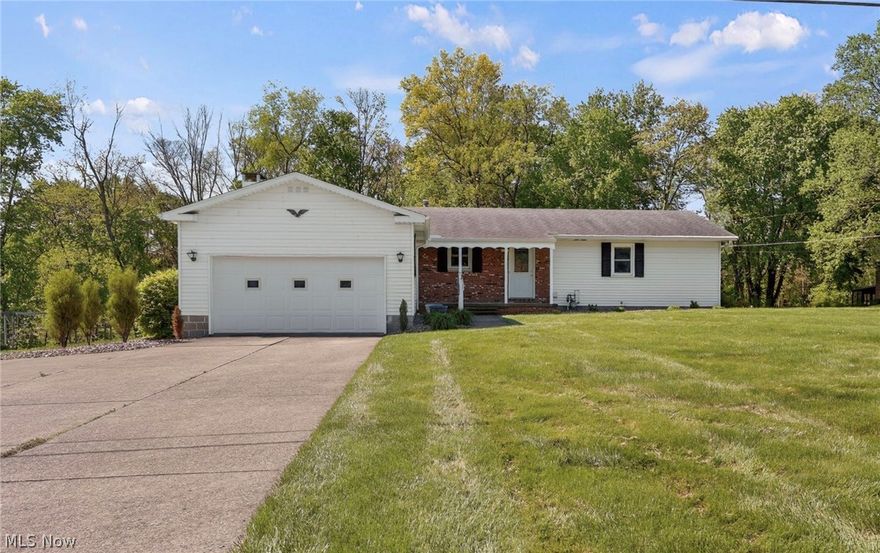 Step into charm and opportunity with this well-cared for 3 bedroom, 2 bath ranch home located in Triway! Nestled on just over a half-acre, this property offers peaceful views overlooking a big backyard and wooded ravine. Inside, you’ll love the open atmosphere highlighted by a beautiful gas fireplace, large windows filling the home with natural daylight. Many updates have already been completed, including newer windows, furnace, front doors, stylish barn doors, upgraded bathroom features and dishwasher. The full basement offers endless possibilities with plenty of space for storage, hobbies, recreation, or future finished living space. An added bonus is the 13x14 storage area tucked beneath the rear corner of the home, perfect for lawn equipment, gardening tools, and seasonal storage. Enjoy relaxing on your front porch this summer! This is the kind of property you've been waiting for that's just waiting for your personal touches. Schedule your showing today!