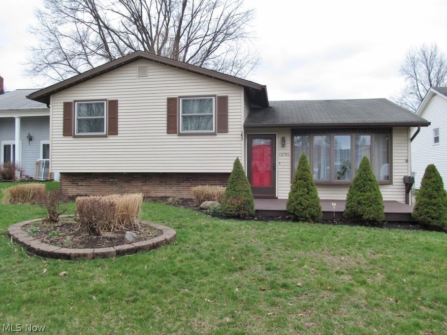 Be first or be sorry! Pride of ownership! 3 bedroom, 2 full bath split level home features updated kitchen with granite look-a-like counter tops, island, tile back splash and Kraftmaid cabinets. Living room includes a stone gas log fireplace and bay window. Lower level family room boasts wine bar, cork flooring,  modern full bath, laundry room with extra cabinets and glass block windows. All bedrooms have beautiful hardwood floors and ceiling fans. Bedroom 2 has built in book/trophy shelves. Main bath updated with glass counter top and glass sink. 2.5 car garage with work bench and additional storage. Covered patio. Deck and kitchen updated in 2011. Bathrooms updated in 2010. Garage door 2007. 1 year HMS Home Warranty.