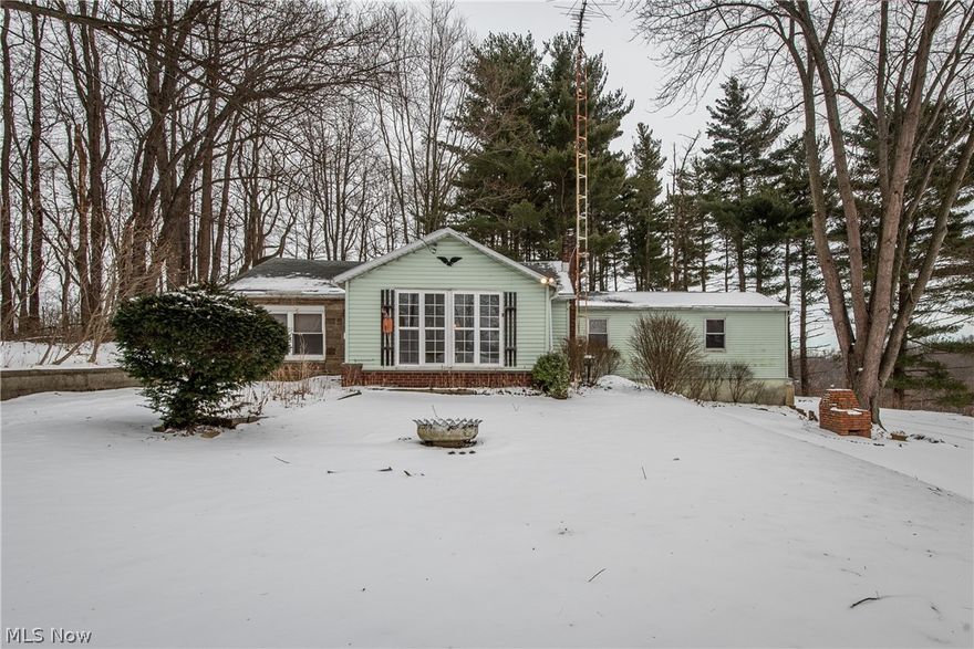 RANCH ON 4.5 WOODED ACRES!  Surrounded by trees and privacy, there is plenty of potential for the savvy investor to turn this into a dream home.  A sunroom entrance opens into the foyer with enough space for a home office.  The spacious living room offers an open view into the dining room.  The kitchen has room for a dinette, plenty of cabinets, appliances, and door to the backyard.  Bedroom 1 has a sliding door to the patio while the 2nd bedroom includes a large private sitting area. The home had three bedrooms at one time but was opened up to make one larger bedroom. The full basement adds room for storage and access to the garage.  If you're looking for a home in need of some TLC but offers seclusion and country views, this is it! Check out the pictures from this past fall. What a beautiful setting.