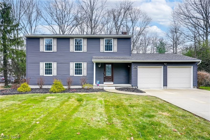 Take a look at this gorgeous 4-bedroom colonial in Hudson! Walking in you'll notice an elegant open foyer, coat closet and a half bathroom, the perfect spot to welcome your guests! Continuing on you'll love the large living room with an abundance of natural light that feeds directly into a dining room and open concept kitchen featuring granite countertops and custom cabinetry! The dining room walks out to the covered screened-in porch, perfect for unwinding in the evening or a cup of coffee and a good book! The first floor also features another fabulous sitting room just off the large two-car garage that features both a warm fireplace and another walkout to the back porch! The second level boasts all four bedrooms as well as two recently refreshed bathrooms! The main suite has its own full bathroom with wonderful natural light and a spacious shower! Each room has large closets and fresh paint! The lower level has just the right amount of finished area, perfect for a theater room, playr