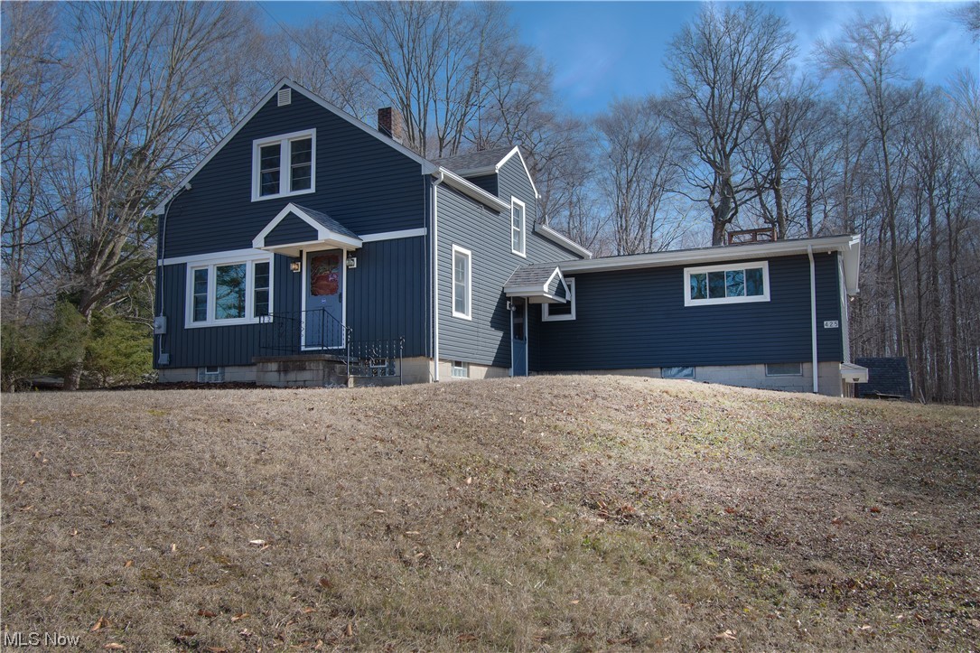 This spacious bungalow sits on a beautiful three-acre lot in Marlington school district. As you enter this beautifully updated home, you will love how bright and airy it is. The first floor has a lovely family room with laminate flooring and modern colors, two bedrooms, a full bathroom, an adorable kitchen, and a spacious great room with a brick wood-burning fireplace and access to the back porch. The private backyard has beautiful wooded views perfect for relaxing during warm summer days. Enjoy family time in the recently updated kitchen with stainless steel appliances, white cabinets, and counter space accented with a subway-tiled backsplash. Upstairs you will find two more bedrooms with new carpet and built-in storage. This home is complete with a laundry area and an attached 2-car garage. Updates include new floors throughout, freshly painted, new appliances, updated kitchen, etc. Don't miss it, and make an appointment for your private showing today!