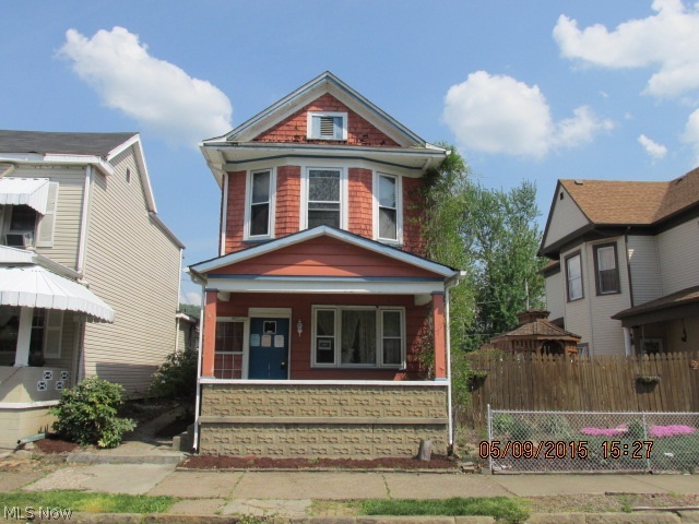 2 story home with a covered front porch, AC, covered balcony, nice yard and 3 bedrooms