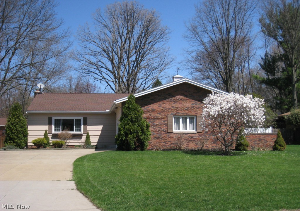 Wow! FABULOUS 3 bedroom 2.5 bath split level. Big beautiful maple kitchen with upscale cabinetry, rich granite counter tops, gorgeous buffet and matching maple bench w/coat rack and wide plank maple flooring. An open staircase overlooks the spacious cathedral living room. A few steps down leads to the 30' family room with a stone fireplace. The second kitchen/workshop/laundry area is a great space for your personal hobbies. A fantastic sun porch surrounded by windows overlooks the 2 level patio and large private lot. Nice master suite with full bath. Major updates include new windows and roof in 2005, updated master bath, guest bath, totally renovated sun porch, updated kitchen, paint, carpet and so much more. Larger than it looks...an absolute must see!