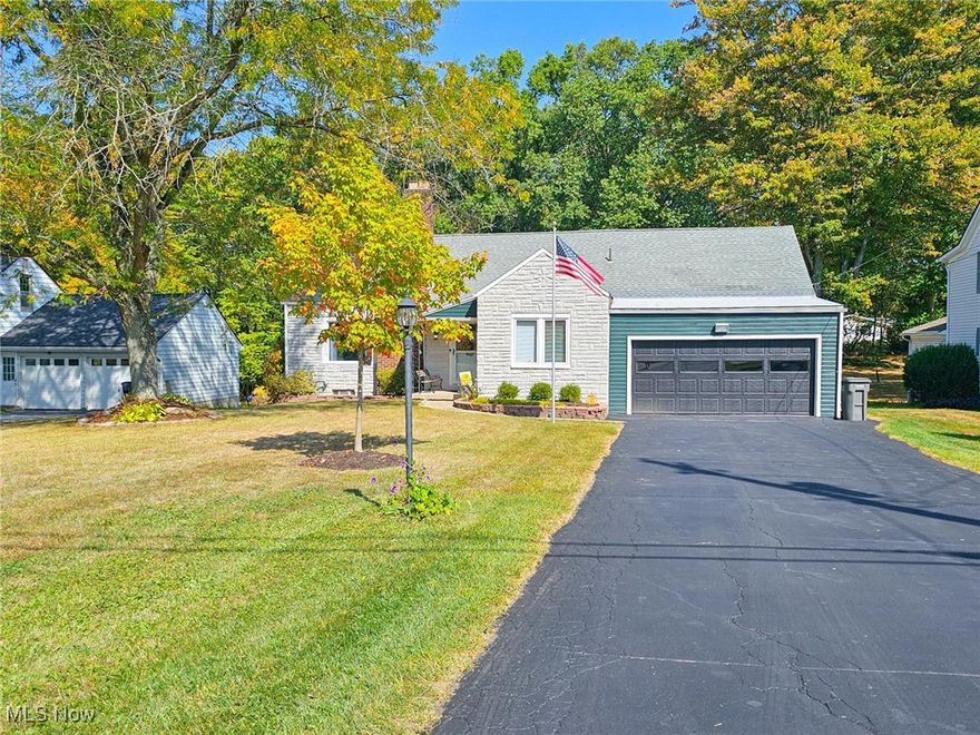 Canfield Schools. This updated Cape Cod has much to offer. Large Living Room with hardwood floors and massive stone gas fireplace. Fantastic, updated kitchen with traditional oak cabinets, granite counter tops and hardwood floors. Edison lighting with built in fan, ceramic tile backsplash and stainless-steel appliances. Double oven, refrigerator 2024 and dishwasher 2022. A “Where did you get” chandelier over the table completes this kitchen. Large 2 tier family room offers entertain area for young and old at the same time! Built in bar for the adults, with built in cabinet with live edge back bar, carpeted area for the children and each with a TV. Step outside to the 12 X 20 covered deck with fan, TV and remote-control sunscreen. The Azek deck with cedar ceiling connects the home with the outside experience. The 2 full bathrooms have been recently remodeled.  Main bath with granite and soft close doors/cabinets. The upstairs bath also features granite counter top. The 2 lower bedrooms feature hardwood floors. The carpeted upstairs bedroom and family room are kept comfortable by the new mini-split heating and cooling system. This summer's heat was no problem as a new AC was installed in 2025.
