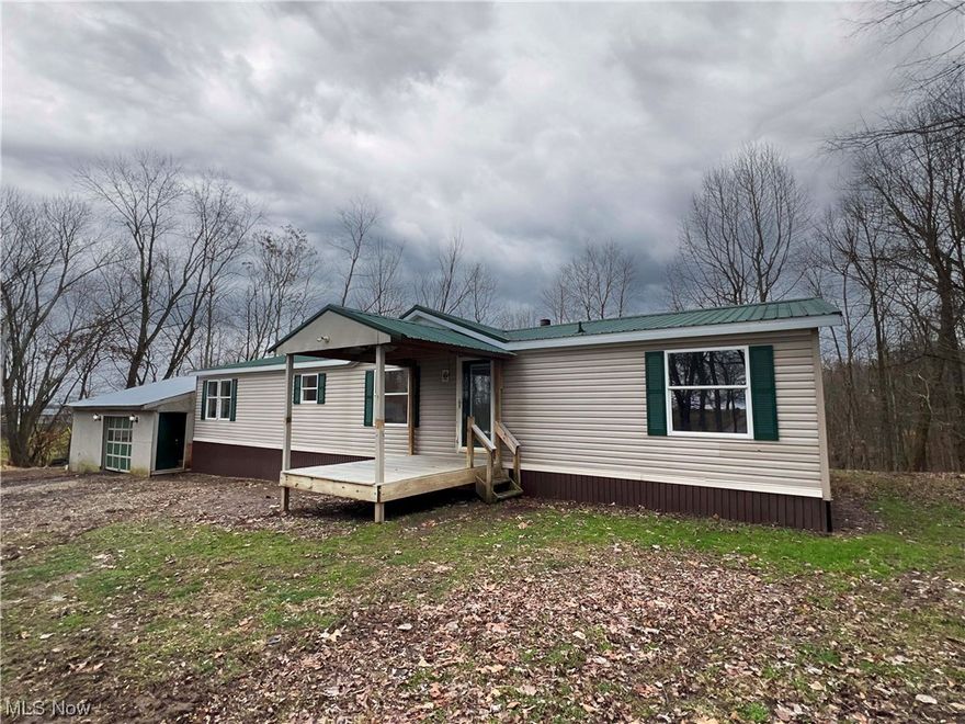 Move into the country and enjoy this recently renovated double wide with an attached garage. Tucked away on a quiet street is this 3 bedroom, 2 full bath home that has new flooring, fresh paint and is basically move in ready. Enter into the large open dining and kitchen area as well as the laundry room. Against the laundry room you will find a garage that is cleaned out and ready to go. Outside you have the benefit of having 1 acre to live on with a small woods right behind the house. Recently the water pump has been redone and the septic has a new riser and lid. Stop in and make this property yours! Perfect rental property if investing is your game.
