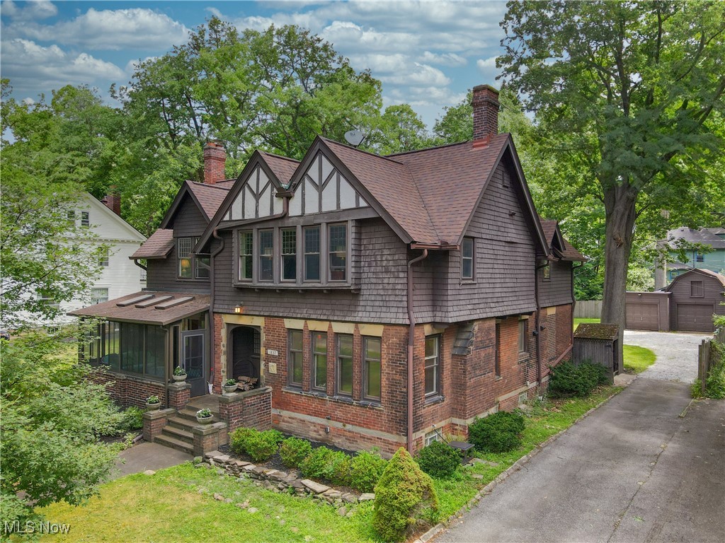 Blending the storied elegance of early 20th-century architecture with thoughtfully curated updates, this remarkable turn-of-the-century Tudor captures the very essence of gracious living in the Heights. Behind its stately façade lies a beautifully proportioned interior rich with millwork, character, and light. The expansive entry sets the tone with gleaming hardwood floors and finely crafted moldings that lead you into a relaxing family room—anchored by a wood-burning fireplace and flanked by an enchanting sunroom wrapped in glass that has been enjoyed for generations. Retreat into the sunlight-drenched den—an inspiring office or potential 4th bedroom - that opens effortlessly to the rear porch through custom Pella sliding doors. At the heart of the home, the generously sized kitchen offers the perfect marriage of function and form, with ample counter space, classic cabinetry, a gas range, deep farmhouse-style sink, and serene views of the private, fenced backyard. Current owners have elevated the space with new backsplash, counter tops and fresh paint. The adjacent dining room is a showstopper, framed by tall windows and a second wood-burning fireplace. An updated full bath completes the main level, designed with convenience in mind. Upstairs, the owner's suite serves as a peaceful sanctuary with its private bath, custom closet, and discreetly tucked-away laundry. Two additional bedrooms—well appointed, spacious and featuring updated windows—share a stylish full bath off the generous landing. Outdoors, an expansive composite deck provides the ultimate setting for al fresco gatherings. BONUS private hot tub invites year-round fun and relaxation, all overlooking a lush, deep backyard embraced by privacy fencing. Located just a stone’s throw from the vibrant shops, restaurants, and green spaces of Coventry, and with easy access to the Cleveland Clinic, Case Western Reserve, and University Circle, this residence is a rare find in an excellent location!