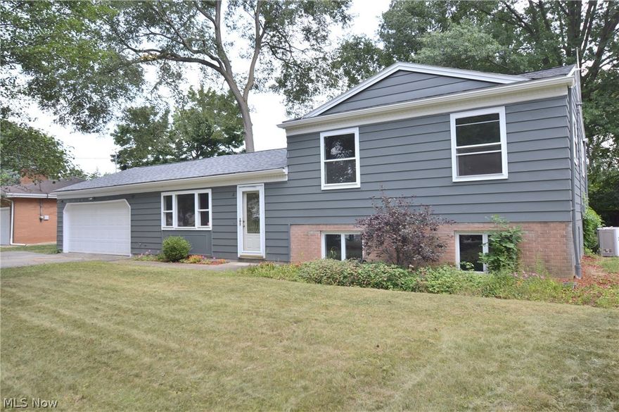 This completely updated move-in ready split level home in Austintown schools is absolute perfection! Located in a quaint neighborhood, this home is ready to be lived in and enjoyed! As you walk through the front door you will notice the cool tranquil colors that compliment the beautiful finishes throughout the home. The main floor plays host to a large living room that flows nicely to the breath taking updated kitchen with stainless steel appliances and island that offers plenty of storage and enough space for an eat-in kitchen. Entertaining and hosting will be a breeze with the open and comfortable layout, with one glance you can view the living room, kitchen and  huge family room with a fireplace and access to the back patio. The second floor you will find three bedrooms with huge closets and a stunning updated full bath with tiled shower! The lower level can be used as a huge master suite with a full bath and huge closet. Enjoy any hobby your heart desires with your spacious attache