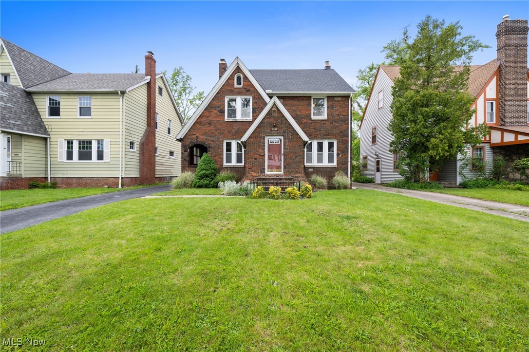 Tucked along a peaceful, tree-lined street, this classic brick Tudor blends timeless architectural charm with thoughtful modern updates throughout. Step inside to a warm, welcoming entryway that opens into a spacious living room filled with natural light, featuring newly restored hardwood floors & a classic fireplace, offering the perfect blend of comfort & character. Just off the living space, a covered side porch adds charm & serves as a peaceful extension of the home, ideal for morning coffee or quiet evenings. Continue into the formal dining room, where original built-ins add both function & character, creating a beautiful space for hosting & gathering. The spacious kitchen features granite countertops, sleek cabinetry, stainless steel appliances & new tile flooring, along with a cozy breakfast nook that invites casual meals & morning rituals. From the kitchen, you'll be led to a rare, practical mud area & a charming, updated powder room, both of which elevate the home’s everyday convenience. Upstairs you'll find three comfortable bedrooms, a beautifully updated full bath & a bright nook perfect for reading, remote work or quiet reflection. The third floor offers a flexible retreat with lofted ceilings, plush carpeting, a generous closet & a stylish half bath. It's ideal for a primary suite, teen space or guest quarters. A clean, unfinished basement provides ample storage & future potential, while the detached two-car garage adds everyday functionality. The backyard offers a green, low-maintenance space to enjoy as is or customize with a personal touch!. Curb appeal shines with classic Tudor details, enhanced by a newer roof & updated windows. This POS-compliant home is minutes from John Carroll University, coffee shops, restaurants, shopping & major hospital campuses. With so many upgrades, this move-in-ready home offers peace of mind & is simply awaiting your personal touches.