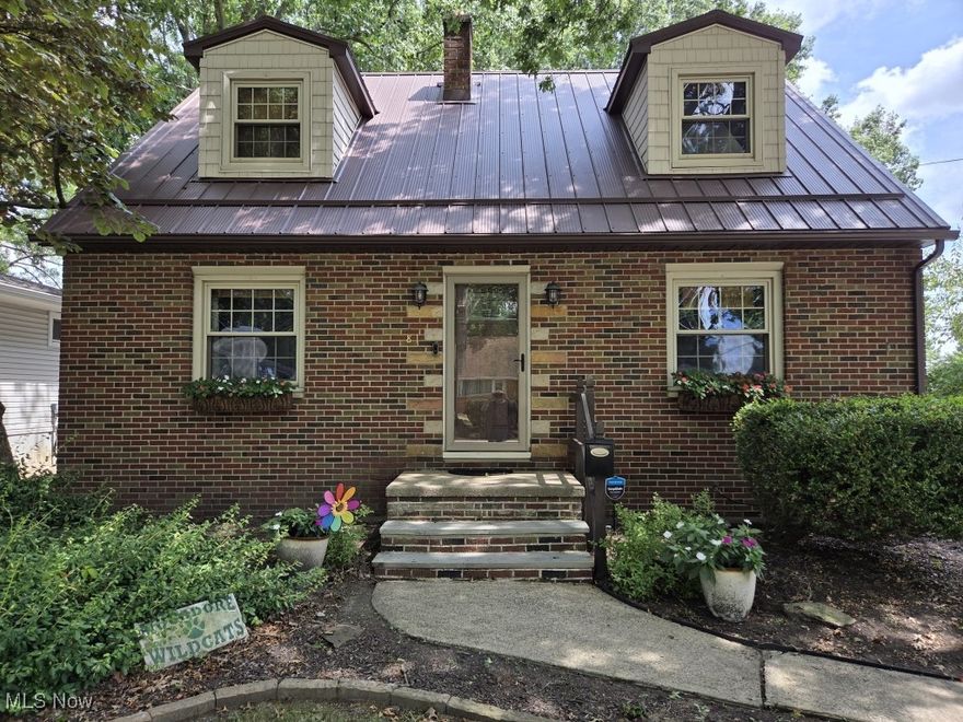 Welcome to 81 Hale in Mogadore" a home that truly shines! This well-maintained property offers 3 spacious bedrooms, 4 bathrooms (3 full and 1 half) and a walk-out basement. A huge bonus is the first-floor master suite addition, which features a fully remodeled bathroom and a cozy wood-burning fireplace. The home has seen numerous updates, including a complete kitchen remodel with updated hardwood floors, lighting and custom wood blinds, a new metal roof in 2022, a stamped concrete hot tub patio added in 2023, a wood burner installed in the living room in 2022, fresh paint throughout, an updated upstairs bathroom in 2022, new interior doors and a basement bathroom with new flooring. Exterior updates include a wood privacy fence (2021) and a new retaining wall (2022). The walk-out basement opens to a covered patio with a second wood-burning fireplace, ceiling fan, electric hookup for a TV and a storage room" perfect for entertaining or relaxing year-round. Additional features include a large deck, furnace replaced about 10 years ago, hot water tank (2019), A/C about 9 years old, updated concrete driveway, a basketball hoop that stays with the property and a large, private backyard. This home blends charm, thoughtful updates and plenty of space" inside and out.