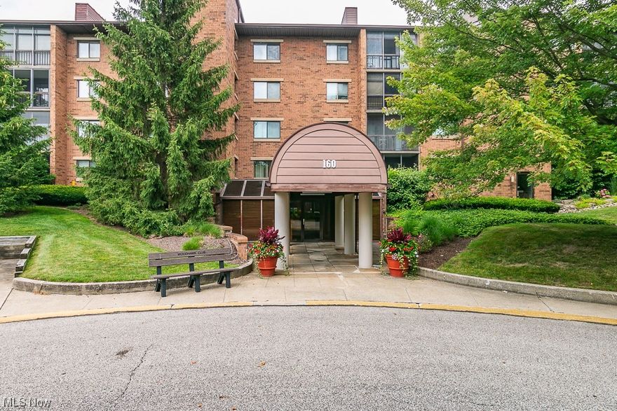 What a fantastic find in the gated community of Woodhawk Club Condos! Located on the main floor, with no stairs to climb is this ranch style unit with nearly 1700 sq ft of living space. A foyer entry opens to the living room with a faux fireplace and wall of windows with sliding door access to the ground level screened in porch. Gather for meals with friends and family in the formal dining room or enjoy casual dining in the kitchen complete with extra seating at the counter and an abundance of cabinet and counter space. There's also access to the screened porch for al fresco dinners! In the hall leading to both bedrooms you'll find the main full bath with a walk-in shower. The incredible master suite boasts three closets and an en suite bathroom with a soaking tub and extended vanity. Additional features include an in unit laundry with full sized appliances and an assigned parking spot in the attached parking garage.  If you're looking for low maintenance living with resort style ameni