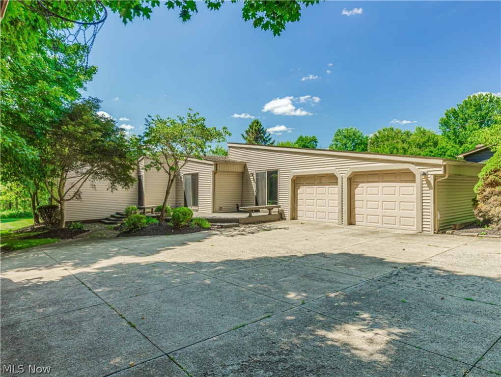 Spectacular Mid-Century Modern Ranch is located at the end of a lingering secluded tree lined drive. Placed in the center of a magnificent 1-acre lot, this is the perfect home if you prefer unique. Boasting the original wide planked wood flooring, beamed vaulted wood ceilings, 3 large bedrooms and updated bathrooms and kitchen. A slider from the kitchen leads to a private deck. All stainless-steel appliances remain. A formal dining room is located off the kitchen and includes transom windows for maximum sunlight. The great room features an eye-catching mid-century fireplace and a wall of windows that leads to the expansive deck. The hot water tank, water softener, and carpet in all three bedrooms have just been replaced. An oversized garage and shed means room for all your outdoor equipment. Lots of extra parking for your big summer parties on this beautiful lot!!!!! Price is right in Tallmadge. Call for your private showing today.