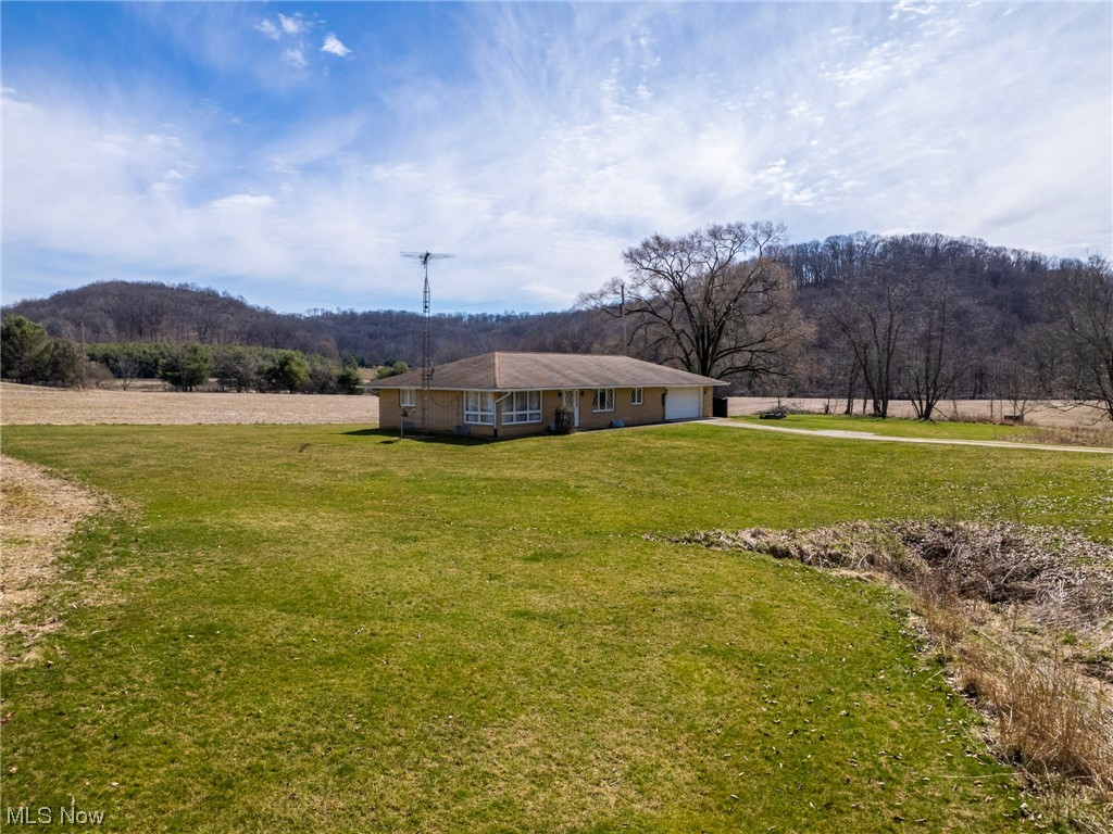 Combined Auction Parcels 1-4. Welcome to your dream property! This absolute auction offers a brick ranch home and is situated on 21.9 acres of prime real estate in the scenic and serene Southeastern Tuscarawas County. With mostly open tillable acres and some wooded acreage, this property offers you the best of both worlds. With four parcels to choose from, you can take your pick of the perfect building site for your dream home or buy it as a whole. The well maintained 3-bedroom 1,440 sq ft ranch home does have a full basement and has main floor laundry along with an attached garage. Utilities include electric, electric heat pump, private well & septic. Don't miss your chance to own this exceptional property – and plan to attend the open house.