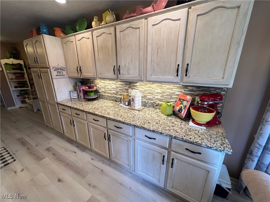 Immaculate 2 bedroom 2 bath vinyl sided ranch on a peaceful 1 acre setting.  Tasteful decor with wood laminate flooring throughout.  Spacious living room and formal dining room.  Beautifully updated kitchen features granite counters, ceramic tile backsplash recessed lighting, under cabinet lighting and newer stainless steel appliances.  Main floor laundry room.   Roomy master suite includes a sizable walk in closet and full bath with jacuzzi tub and walk in shower.  Whirlpool tub in the main floor guest bath.  Full, 11 course basement.  200 amp electric.  Anderson windows.  Whole house stereo with front porch and patio speakers.  New propane furnace in 2016+/- and roof in 2019+/-.  New lighting fixtures.  Newer hot water tank.  Well insulated home.  Large partially covered rear patio provides fantastic scenic views and is the perfect place to relax in private or entertain guests!  Finished 2 car attached garage with attached carport.  Heated and cooled 24 X 28 detached garage includes water and a door opener.  Exclude all contents of the detached garage including but not limited to shelving, wall hangings, workbenches, racks.  Quality built by Valley View Homes.  A must see!