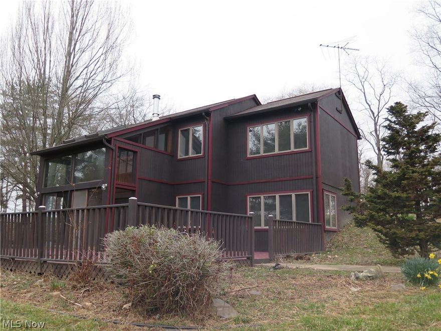 Situated on 9.99 acres of rolling terrain sits a 3 bedroom, 1.5 bath custom home with 2 story glass atrium that overlooks a pond, a 272 ft. cabin, dock, picnic pavilion, and an additional 32 x 48 pole barn. There is an additional garage by the main house that could store 4 more cars. Minutes from Outlet Mall and grocery store.