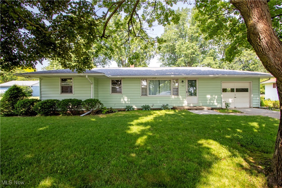 A charming ranch home tucked away in one of Orrville’s most established neighborhoods. Surrounded by mature trees and spacious yards, this home offers a peaceful setting with timeless appeal. Inside, you’ll find three bedrooms, one full bathroom, and many of the original hardwood floors that are still in great condition and add character throughout. The front living room features a large picture window that fills the space with natural light, and the eat-in kitchen provides a cozy spot for everyday dining. While the main floor offers comfortable living, the laundry is located in the basement, which also provides additional storage or potential for future finished space. The home includes a one car attached garage, a newer roof, recently cleaned ductwork, and a serviced HVAC system.
The backyard is open and ready for your personal touch—ideal for relaxing, gardening, or entertaining. A solid, well-kept home in a mature and desirable part of Orrville—come take a look!