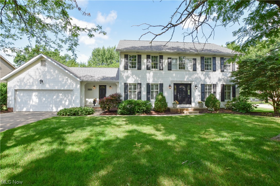 This beautifully updated Colonial in the Eastpointe community is a true gem. The timeless center hall floor plan features a formal living room and dining room flanking the foyer entry with gleaming hardwood flooring that flows throughout the main living areas. The great room is a highlight, featuring a gas fireplace, a bay window, and a convenient office nook. Prepare to be impressed by the kitchen, which offers quartz countertops, a tile backsplash, and a vaulted ceiling with skylights that fill the space with natural light. You'll have plenty of room for dining with both casual seating and counter seating available. The kitchen also opens up to a deck through a patio door, perfect for relaxing and outdoor entertaining. The main level also includes a guest bathroom and a convenient half bath in the mudroom entry that connects to the attached 2-car garage. Upstairs, you'll find four well-appointed bedrooms and two fully remodeled bathrooms. The master bedroom boasts a walk-in closet a